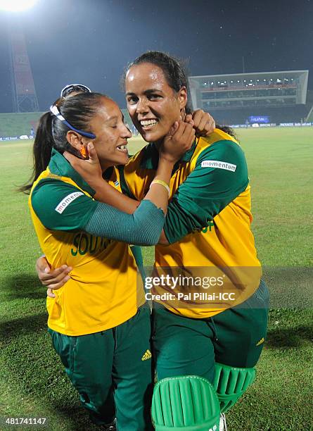Chloe Tryon of South Africa celebrates with teammate Shabnim Ismail after winning the ICC Women's World Twenty20 match between New Zealand Women and...