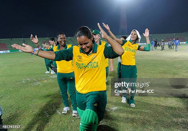 Chloe Tryon of South Africa dances with teammates as they celebrate after winning the ICC Women's World Twenty20 match between New Zealand Women and...