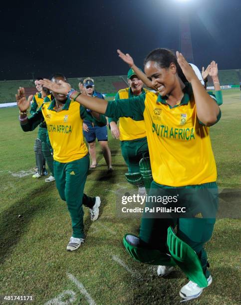 Chloe Tryon of South Africa dances with teammates as they celebrate after winning the ICC Women's World Twenty20 match between New Zealand Women and...