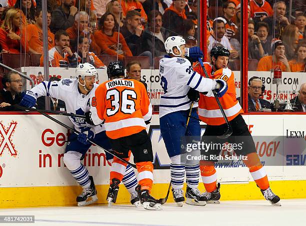 Jay McClement and Colton Orr of the Toronto Maple Leafs battle Zac Rinaldo and Adam Hall of the Philadelphia Flyers at Wells Fargo Center on March...