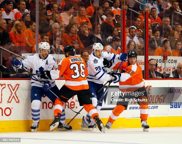 Jay McClement and Colton Orr of the Toronto Maple Leafs battle Zac Rinaldo and Adam Hall of the Philadelphia Flyers at Wells Fargo Center on March...