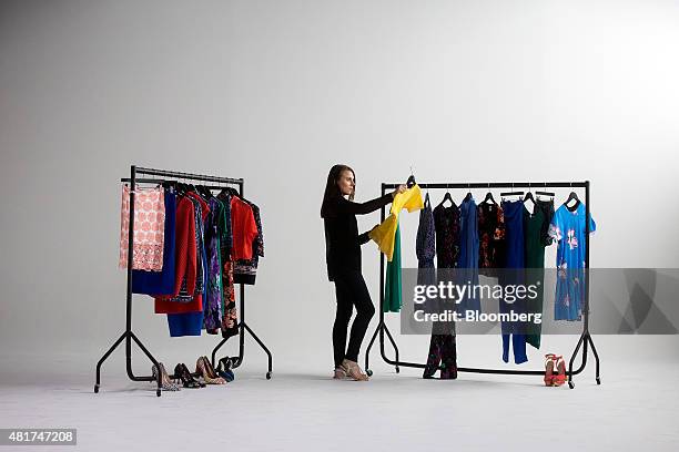 An employee poses for a photograph at Amazon.com Inc.'s new fashion photography studio in the Shoreditch district of London, U.K. In this arranged...