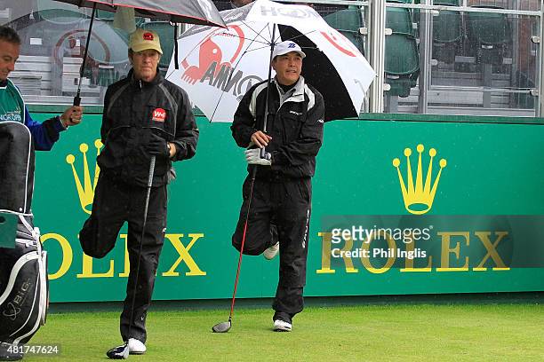 Pedro Linhart of Spain and Lianwei Zhang of China limber up on the 1st tee during the second round of the Senior Open Championship played at The Old...