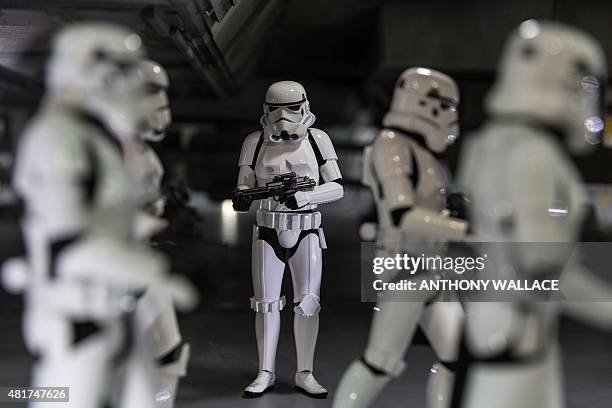 Figurines of 'Storm Troopers' are displayed under a model of the Millennium Falcon from the Star Wars movies at the 17th Ani-Com and Games exhibition...