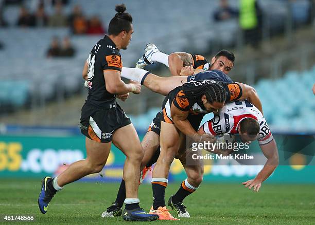 Boyd Cordner of the Roosters is tackled during the round 20 NRL match between the Wests Tigers and the Sydney Roosters at ANZ Stadium on July 24,...