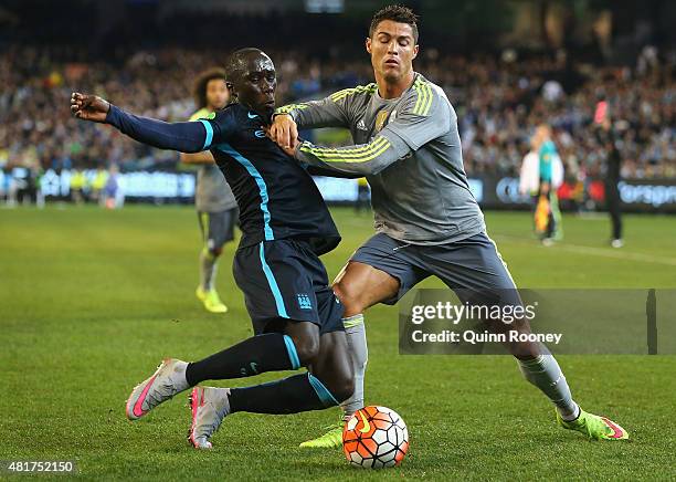 Bacary Sagna of Manchester City and Cristiano Ronaldo of Real Madrid compete for the ball during the International Champions Cup match between Real...