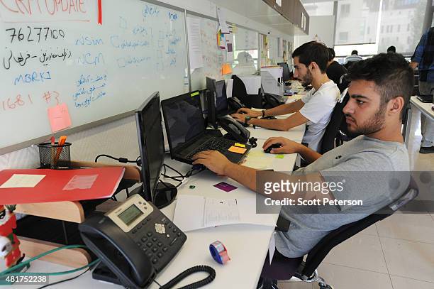 Young Iranian high-tech and start-up specialists work their computers at Sarava, a local venture capital firm that invests in start-ups at Pardis...