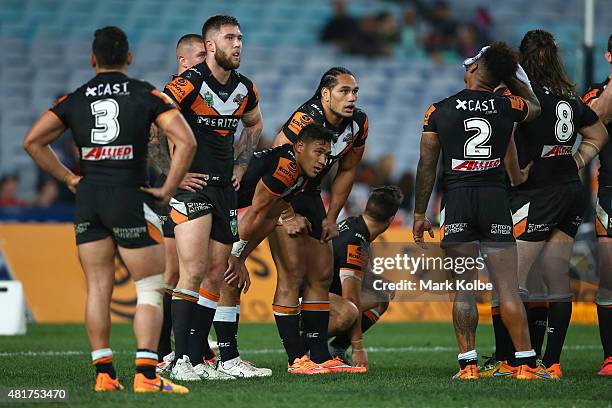 The Tigers team look dejected after a Roosters try during the round 20 NRL match between the Wests Tigers and the Sydney Roosters at ANZ Stadium on...