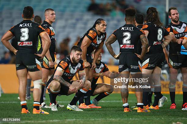 The Tigers team look dejected after a Roosters try during the round 20 NRL match between the Wests Tigers and the Sydney Roosters at ANZ Stadium on...