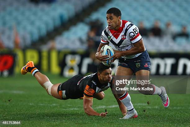 Michael Jennings of the Roosters makes a break during the round 20 NRL match between the Wests Tigers and the Sydney Roosters at ANZ Stadium on July...