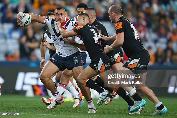 Sio Siua Taukeiaho of the Roosters is tackled during the round 20 NRL match between the Wests Tigers and the Sydney Roosters at ANZ Stadium on July...