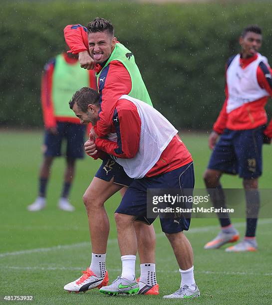 Arsenal's Olivier Giroud and Jack Wilshere mess around during a training session at London Colney on July 24, 2015 in St Albans, England.