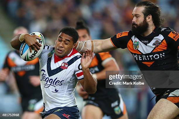 Michael Jennings of the Roosters is tackled by Aaron Woods of the Wests Tigers after making a break during the round 20 NRL match between the Wests...