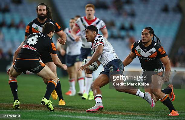 Michael Jennings of the Roosters makes a break during the round 20 NRL match between the Wests Tigers and the Sydney Roosters at ANZ Stadium on July...
