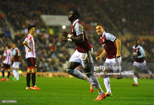 Mohamed Diame of West Ham celebrates with teammate Mark Noble after scoring his team's second goal during the Barclays Premier League match between...