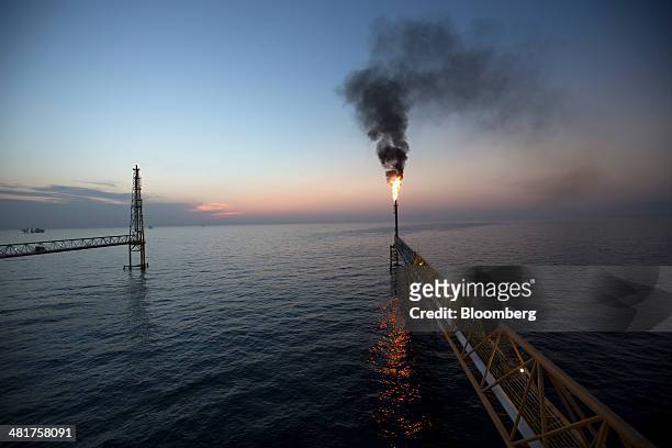 Gas flares from a burner tower on the Petroleos Mexicanos Pol-A Platform complex, located on the continental shelf in the Gulf of Mexico, 70...