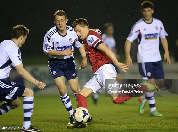 Thomas Eisfeld of Arsenal shoots under pressure from Rob Holding of Bolton during the match between Bolton Wanderers U21 and Arsenal U21 in the...
