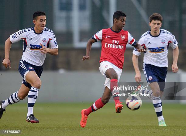 Gedion Zelalem of Arsenal races away from Luke Woodland of Bolton during the match between Bolton Wanderers U21 and Arsenal U21 in the Barclays...
