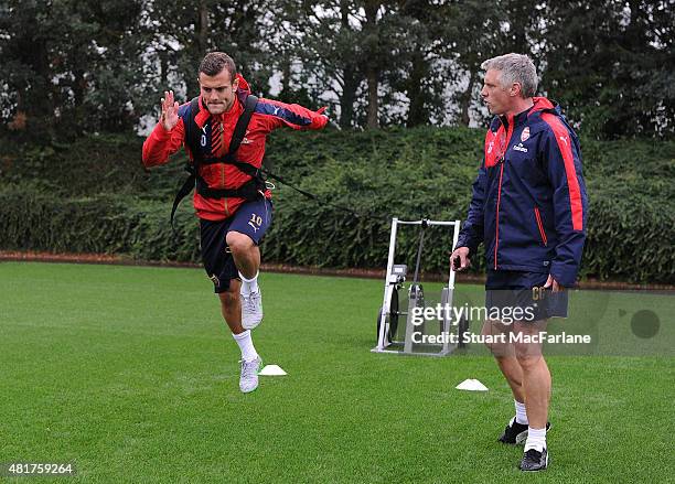 Jack Wilshere with fitness coach Craig Gant during a training session at London Colney on July 24, 2015 in St Albans, England.