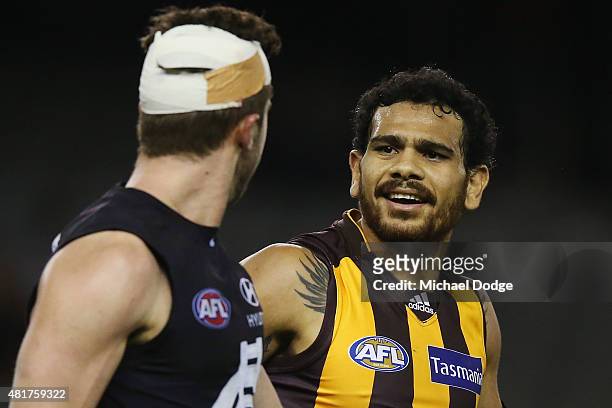 Cyril Rioli of the Hawks reacts at Marc Murphy of the Blues after he laid a heavy tackle on him during the round 17 AFL match between the Carlton...