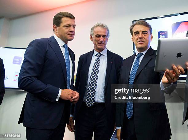 Alexandre de Juniac, chief executive officer of Air France-KLM Group, right, holds an Apple Inc. IPad as he stands with Frederic Gagey, chief...