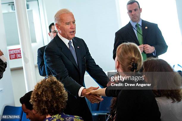Vice President Joe Biden shakes hands with attendees as he visits a sign up site for the Affordable Care Act at the Carlos Rosario International...