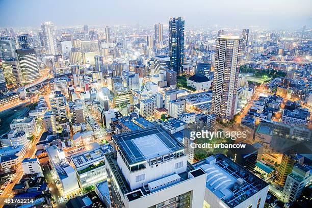 osaka cityscape at night, illuminated high rise buildings, japan - osaka prefecture stock pictures, royalty-free photos & images