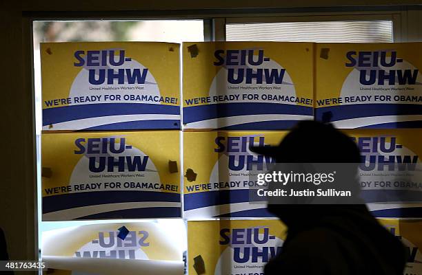 Posters about Obamacare are posted on a window during a healthcare enrollment fair at the Bay Area Rescue Mission on March 31, 2014 in Richmond,...