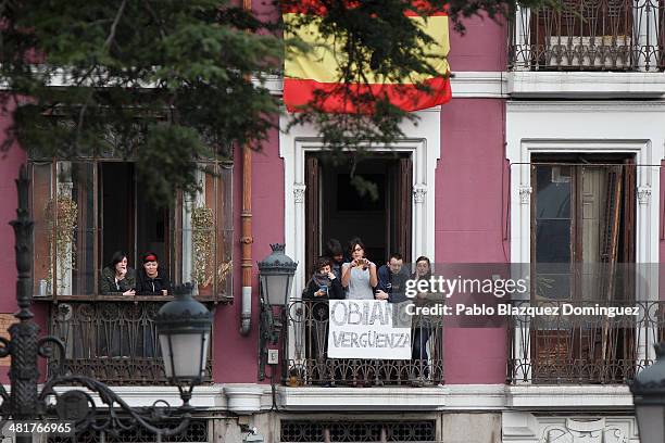 People hold a banner reading 'Obiang shame' in a balcony during the state funeral for former Spanish prime minister Adolfo Suarez in front of the...
