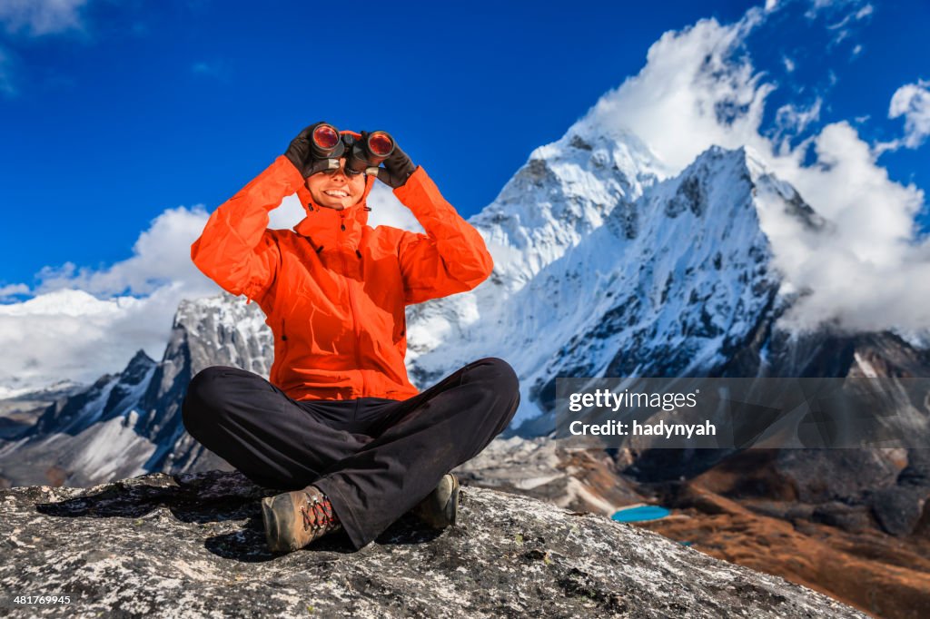 Woman using binoculars in Mount Everest National Park, Nepal