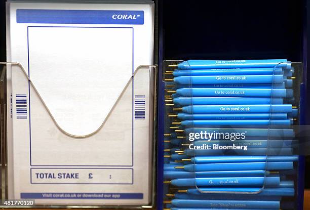 Betting slips and pens sit on a table inside a branch of Coral bookmakers, operated by Gala Coral Group Ltd., in London, U.K., on Friday, July 24,...