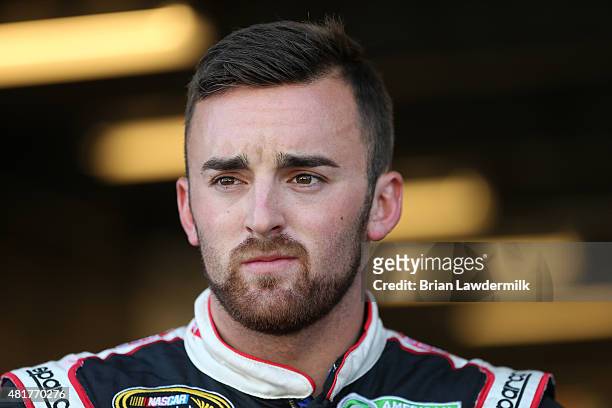 Austin Dillon, driver of the Dow/Mycogen Chevrolet, stands in the garage area during practice for the NASCAR Sprint Cup Series Crown Royal Presents...