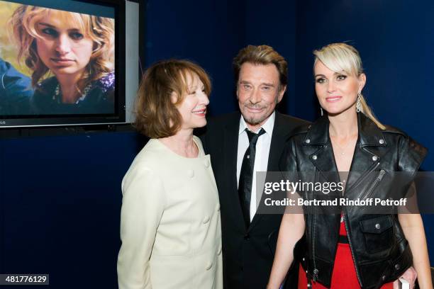 Actor/singer Johnny Hallyday poses with his wife Laeticia and his former partner, actress Nathalie Baye, during the premiere of French director...