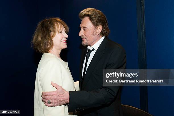 Actor/singer Johnny Hallyday hugs his former partner, actress Nathalie Baye during the premiere of French director Claude Lelouch's film "Salaud, on...