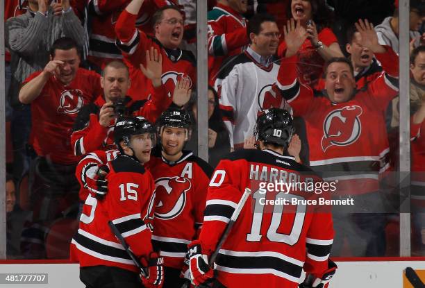 Travis Zajac of the New Jersey Devils celebrates his third goal of the game against the Florida Panthers along with Tuomo Ruutu and Peter Harrold at...