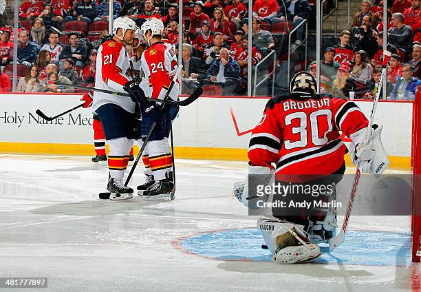 Brad Boyes of the Florida Panthers is congratulated by teammate Krys Barch after scoring a second-period goal as Martin Brodeur of the New Jersey...
