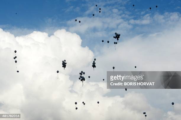 Family members and relatives of the victims of the crash of the Germanwings plane throw 149 white balloons during a ceremony on July 24, 2015 in Le...