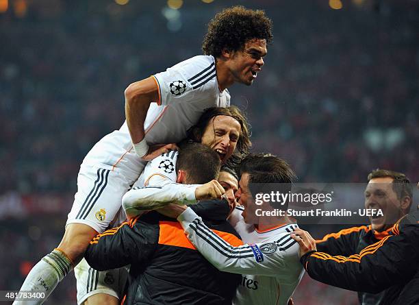 Cristiano Ronaldo of Real Madrid is mobbed by team mates after his second goal during the UEFA Champions League Semi Final second leg match between...