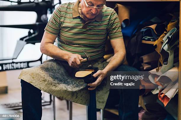 shoemaker putting sole on shoe. - leather boot stock pictures, royalty-free photos & images