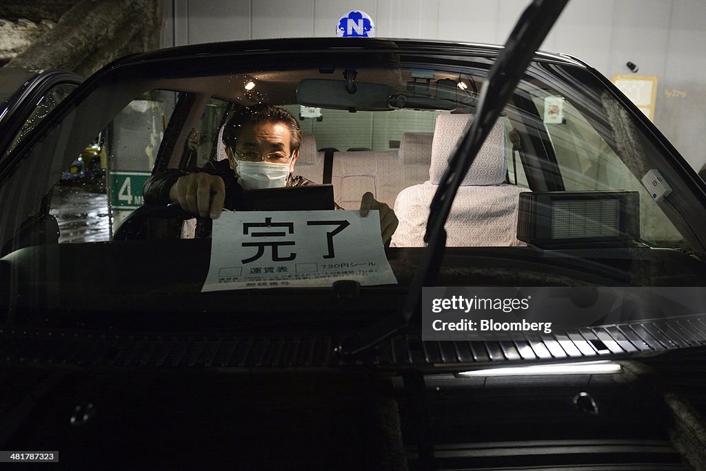 Price Signs On Nihon Kotsu Co. Taxies Are Changed In Garage As Japan Increases Sales Tax