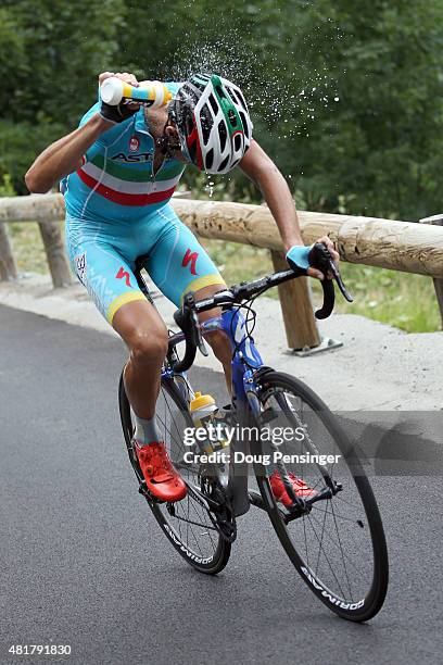 Vincenzo Nibali of Italy riding for Astana Pro Team douses himself with water as he races to victory in stage 19 of the 2015 Tour de France from...