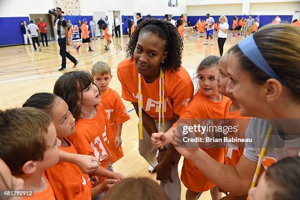 Tamika Catchings of the Indiana Fever huddles a group of kids during a WNBA Fit All-Star Clinic presented by Kaiser Permanente at the Mohegan Tribe...