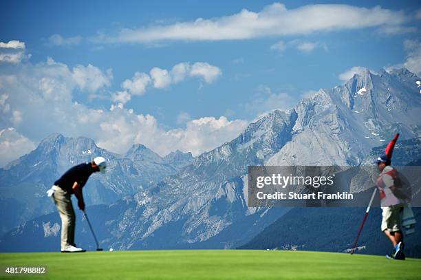 Player putts with the Alps in the background during the second round of the Omega European Masters at Crans-sur-Sierre Golf Club on July 24, 2015 in...