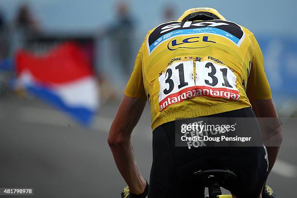 Chris Froome of Great Britain riding for Team Sky in the overall race leader yellow jersey makes the final climb to a third place finish in stage 19...