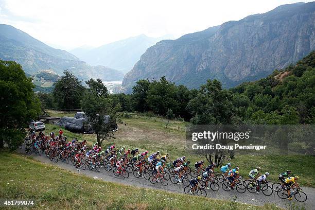 Chris Froome of Great Britain riding for Team Sky in the overall race leader yellow jersey makes the climb of the Col du Chaussy with the peloton as...