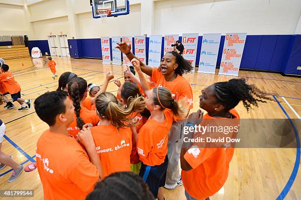 Tamika Catchings of the Indiana Fever huddles with fans during a WNBA Fit All-Star Clinic presented by Kaiser Permanente at the Mohegan Tribe...