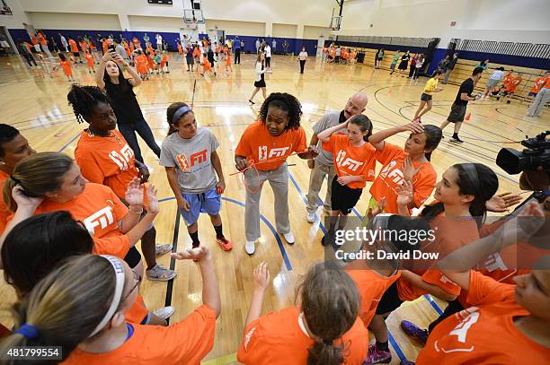 Tamika Catchings of the Indiana Fever huddles with fans during a WNBA Fit All-Star Clinic presented by Kaiser Permanente at the Mohegan Tribe...