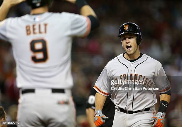 Buster Posey of the San Francisco Giants reacts as he crosses home plate after hitting a two-run home run against the Arizona Diamondbacks during the...