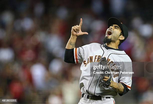 Relief pitcher Sergio Romo of the San Francisco Giants celebrates after defeating the Arizona Diamondbacks in the Opening Day MLB game at Chase Field...