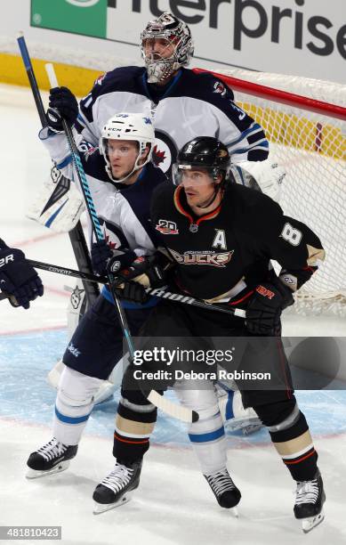 Teemu Selanne of the Anaheim Ducks battles for position against Tobias Enstrom of the Winnipeg Jets on March 31, 2014 at Honda Center in Anaheim,...